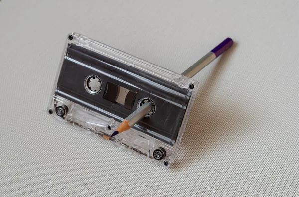 Used a pencil inserted into the audio cassette to rewind the magnetic tape. — Stock Photo, Image