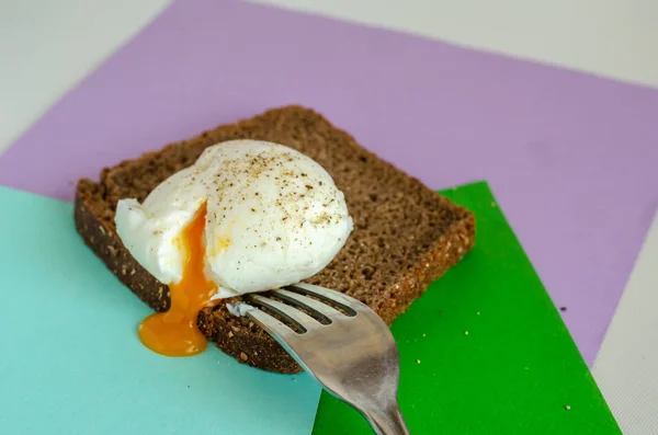 Shelled soft-boiled egg on a piece of rye bread. — Stock Photo, Image