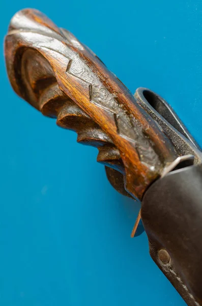 Wooden hilt of an old hunting knife on a blue background. — Stock Photo, Image