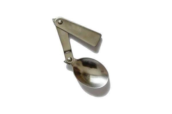 Folding travel spoon. Three-part pocket metal spoon. Hiking, fishing and hunting. View from above. Isolate on a white background.