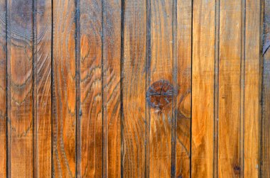 Verniklenmiş tahtalar. Sarı verniklenmiş tahtalardan yapılmış ahşap bir kalkan. Çeşitli görevler için doğal temel. Göz hizasında atış. Yakın plan. Seçici odak.