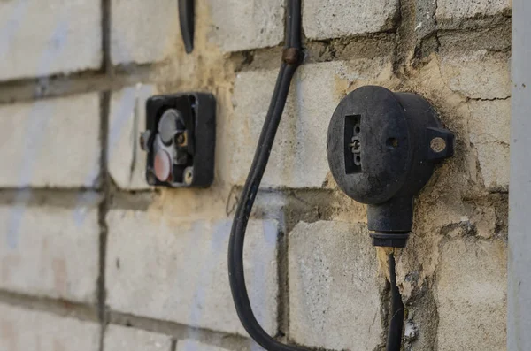 Two Old electrical switches on the wall. Worn out package switch and light switch. Occupational safety at production. Insurance and security. Side view. Close-up. Selective focus.