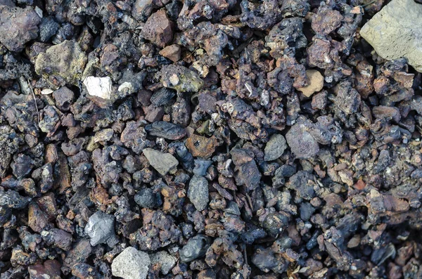 Slag from burnt coal. Coal ash close-up. Coal solid residue texture. Abstract multitask background. Selective focus.