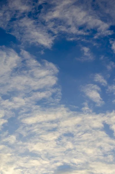 Blue sky background with clouds. Spring blue sky with clouds. Bright colorful sky. Natural background.