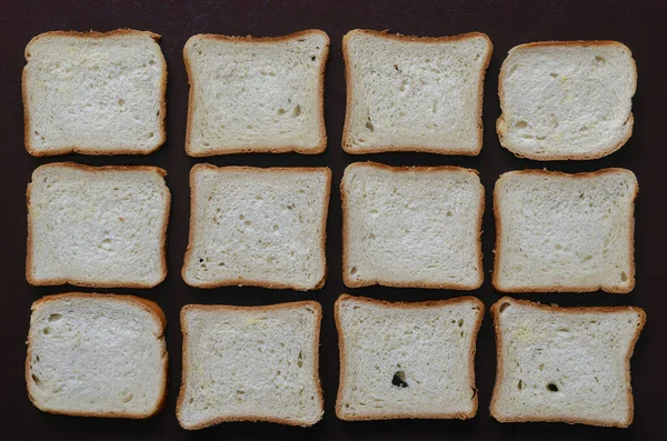 Toast Brood Achtergrond Twaalf Sneetjes Gesneden Brood Een Bruine Textuur — Stockfoto