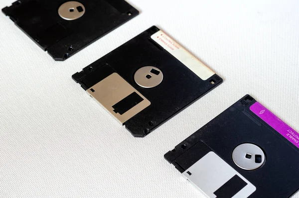 3.5 inch magnetic floppy disks. Three floppy disks with a capacity of 1.44 MB. Obsolete digital data storage media. Close-up. Selective focus.