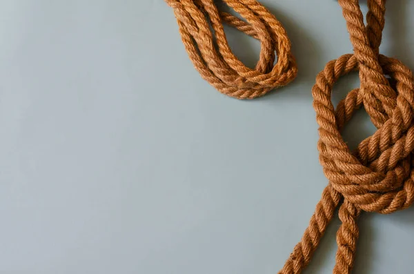 Marine subjects, boating, travel and vacation background. Natural ropes on a light blue background. A variety of twisted hemp ropes. View from above. Copy space