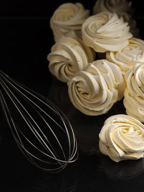 Koyu bir arka planda taze pişmiş ev yapımı şekerlemeler (zephyr). Hamur çırpmak için çırpın. Ev yapımı tatlılar. Dikey yönelim.