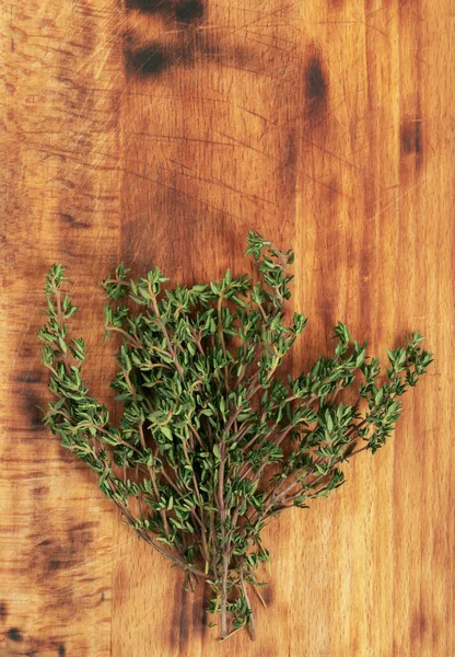 Thyme bunch on the wooden background. Top view, copy space for text. — Stock Photo, Image