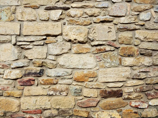 Old castle wall, antique natural stone wall. Pattern gray color, decorative uneven cracked real stone wall surface with cement.