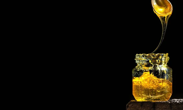 Organic Natural Honey Illuminated Bright Sunlight Glass Jar Black Background — Stock Photo, Image