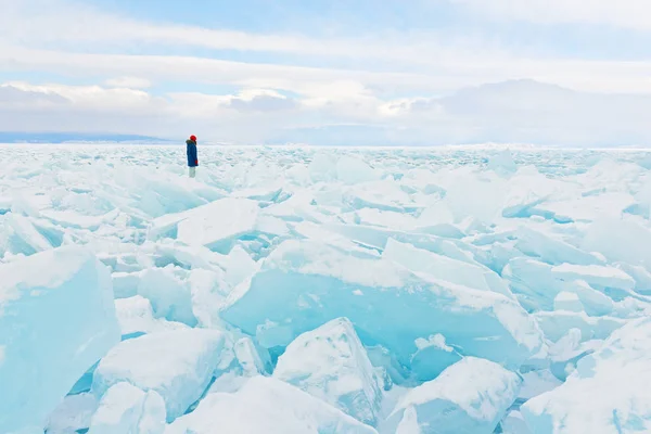Viaggiatore guarda a un campo di ghiaccio che copre il lago Baikal in inverno . — Foto Stock
