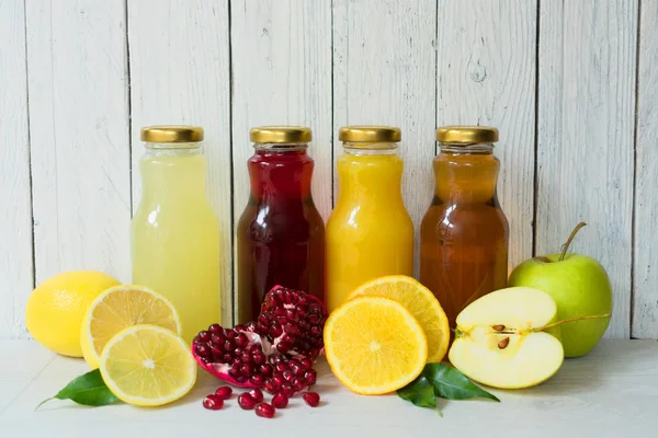 Four Types Juice Pomegranate Apple Lemon Orange Juice Glass Bottles — Stock Photo, Image