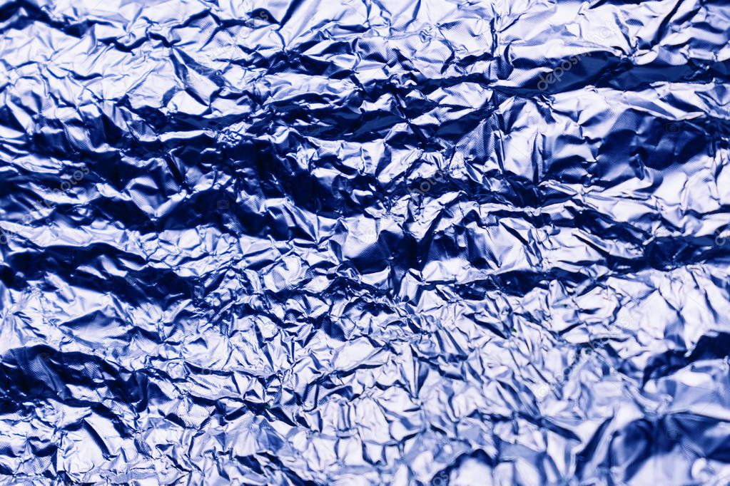  Blue texture of crumpled sheet of aluminum foil. Foil background.