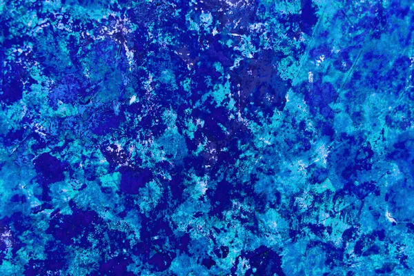 Bright abstract paint background in blue and its shades.