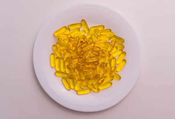 Useful Omega Capsules White Plate Top View — Stock Photo, Image