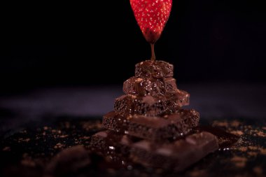 Koyu çikolata tepesinde havada bir kırmızı straberry