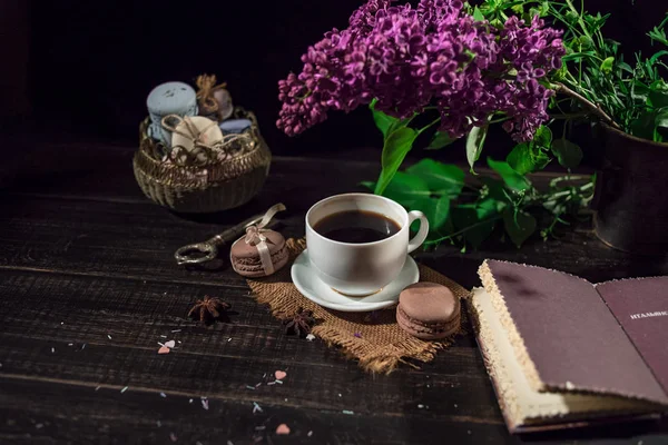 White cup with coffee on a linen napkin and old wooden table — Stock Photo, Image