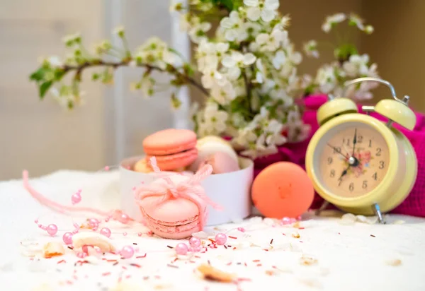 Tender pastel pink and orange macaroons on a white blanket and background — Stock Photo, Image