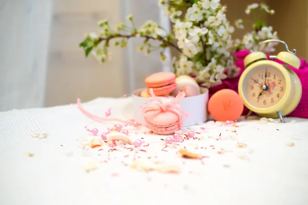 Tender pastel pink and orange macaroons on a white blanket and background — Stock Photo, Image