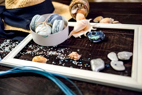 Blue and marine blue macaroons in marine there on a old wood table — Stock Photo, Image