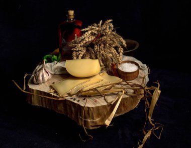 Kraft ahşap masa üzerinde şişe ile sebze ile koyu arka plan üzerinde ev yapımı peynir