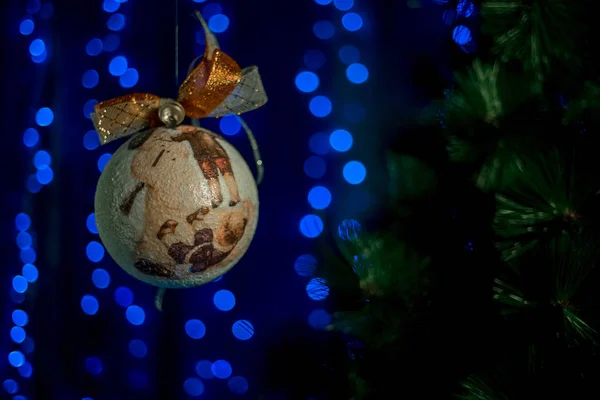 homemade vintage Christmas ball rolling in the air near NewYears Tree.