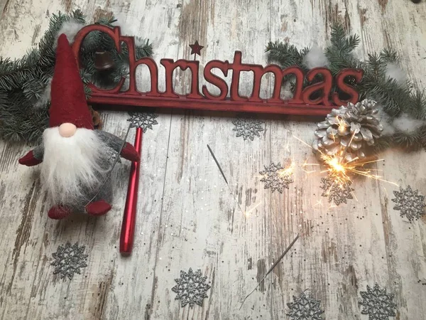 Christmas logo letters on a wood made background with cone and bengal fire (sparkler)  and Tomteland