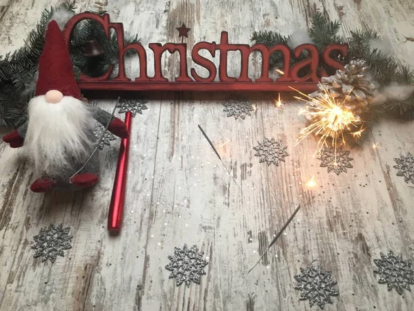 Christmas logo letters on a wood made background with cone and bengal fire (sparkler)  and Tomteland