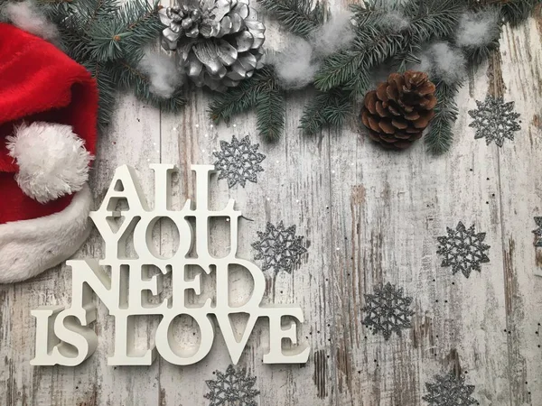 All you need is love logo with Christmas theme on woood background.
