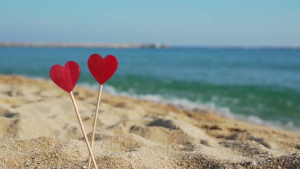 Dos corazones en un palo sobre un fondo del mar y el cielo azul . — Vídeos de Stock