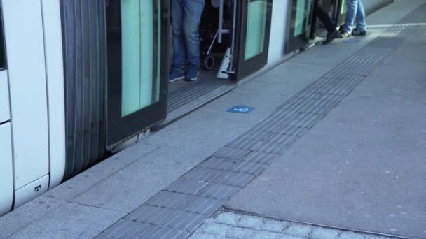 Feet of people getting off the tram at the bus stop — 비디오