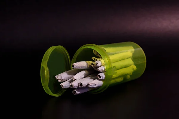 Una bottiglia di pillola verde RX trasparente brillante piena di marijuana — Foto Stock