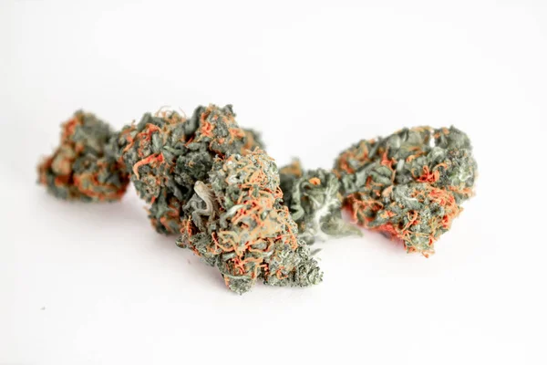 Close up of some large fluffy vibrant marijuana buds with a whit
