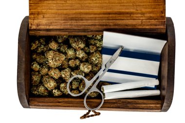 A wooden stash box half filled with green marijuana buds covered clipart