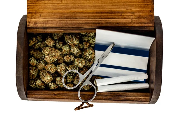 A wooden stash box half filled with green marijuana buds covered — Stock Photo, Image