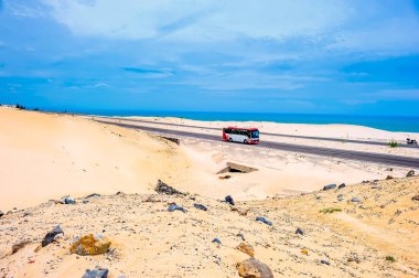 Ulusal otoyolun manzarası Phan Thiet, Binh Thuan, Vietnam 'daki güzel kum tepelerinden geçiyor.