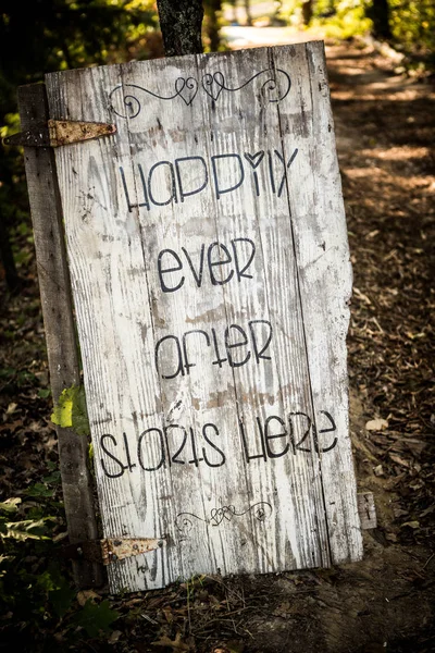 Distressed door with Happily Ever After Starts Here on it.