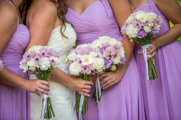 Nevěsta a družičky ve fialové šaty, drží jejich kytice — Stock fotografie