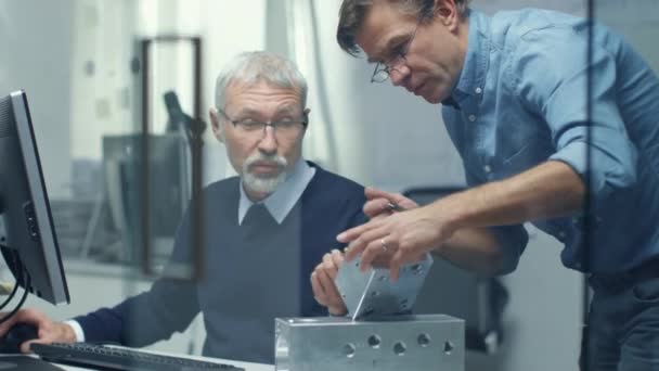 Twee Senior-ingenieurs bespreken belangrijke technische Component. Beide zijn Experienced en Wise. Hun kantoor ziet er Modern en Bright. — Stockvideo