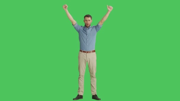 Long Shot of a Happy Casual Man Making Win, Celebration, Success Gestures. Shot on a Green Screen Background. — Stock Video