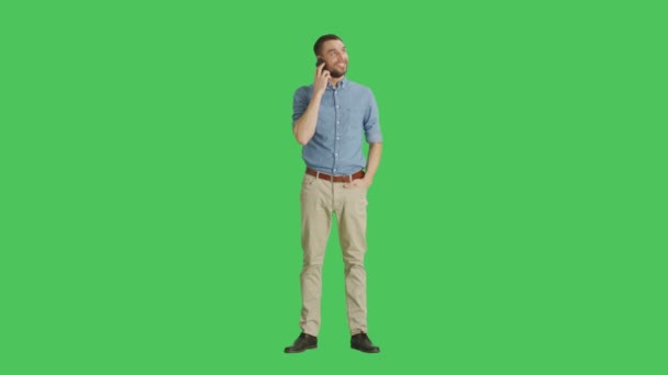 Long Shot if a Handsome Man Talking on a Headset. Shot on Green Screen Background. — Stock Video