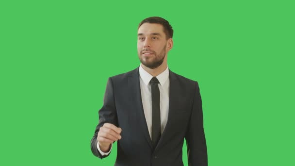 Medium Shot of a Smiling Businessman Making Swiping and Touching Gestures while Standing on a Green Screen Background. — Stock Video