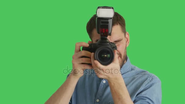 Mid Closeup Shot of a Handsome Photographer Taking Pictures with His Camera. Shot on Green Screen. — Stock Video