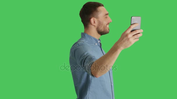 Mid Shot of a Handsome Stylish Man Taking Selfies on a Green Screen Background. — Stock Video