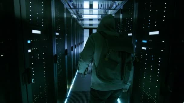 Back View of a Hacker Sneaking in Corporate Data Center. — Stock Video