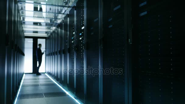 Long Shot of Out of Focus IT Technician Turning on Data Server. — Stock Video