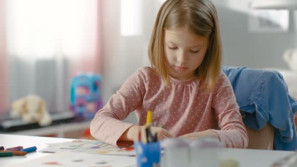 Cute Little Girl Draws with Crayons in Her Light Room. — Stock Video