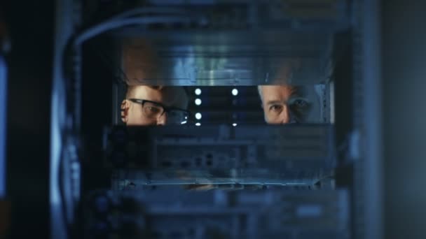 Dois engenheiros de servidor instalam hardware na cremalheira do servidor. Eles trabalham em data center moderno grande . — Vídeo de Stock