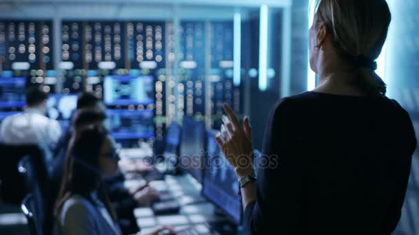 In The Government System Control Center. Female Supervisor Holds Meeting For Her Team of Technical Professionals. They're Workspace is Equipped with Multiple Displays Showing Various Information. — Stock Video